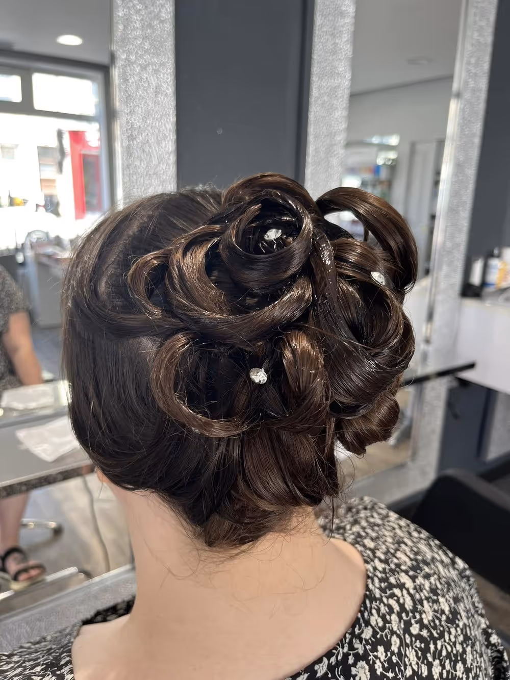 Chignon de cérémonie en boucles roulées, piqué de strass